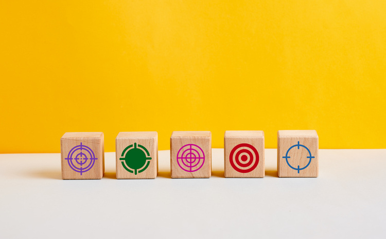 several wooden block lined up with target icon. customer identification, segmentation, target audience concept.