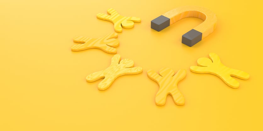 Magnet attracting human figures signifying customer acquisition and retention.