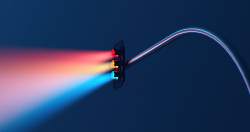 Traffic light with a three-color light beam on a blue background