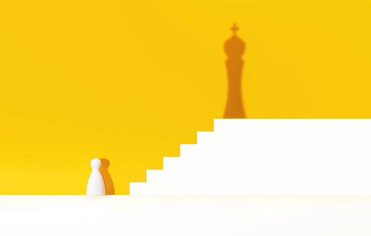 Chess pawn and chess king over yellow background. strategy concept