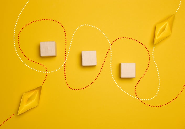 Paper boats and the trajectory of movement, yellow background